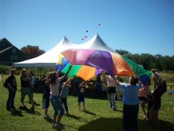 Children playing with parachute at Harvest Fair